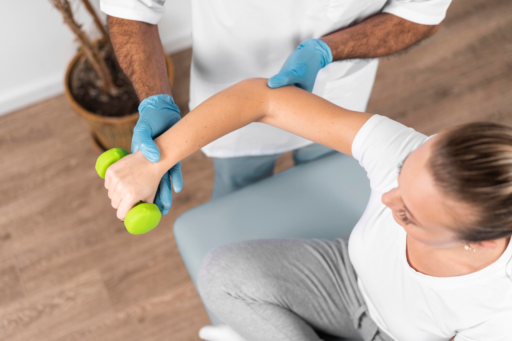 high-angle-male-physiotherapist-checking-woman-s-strength_23-2148780727