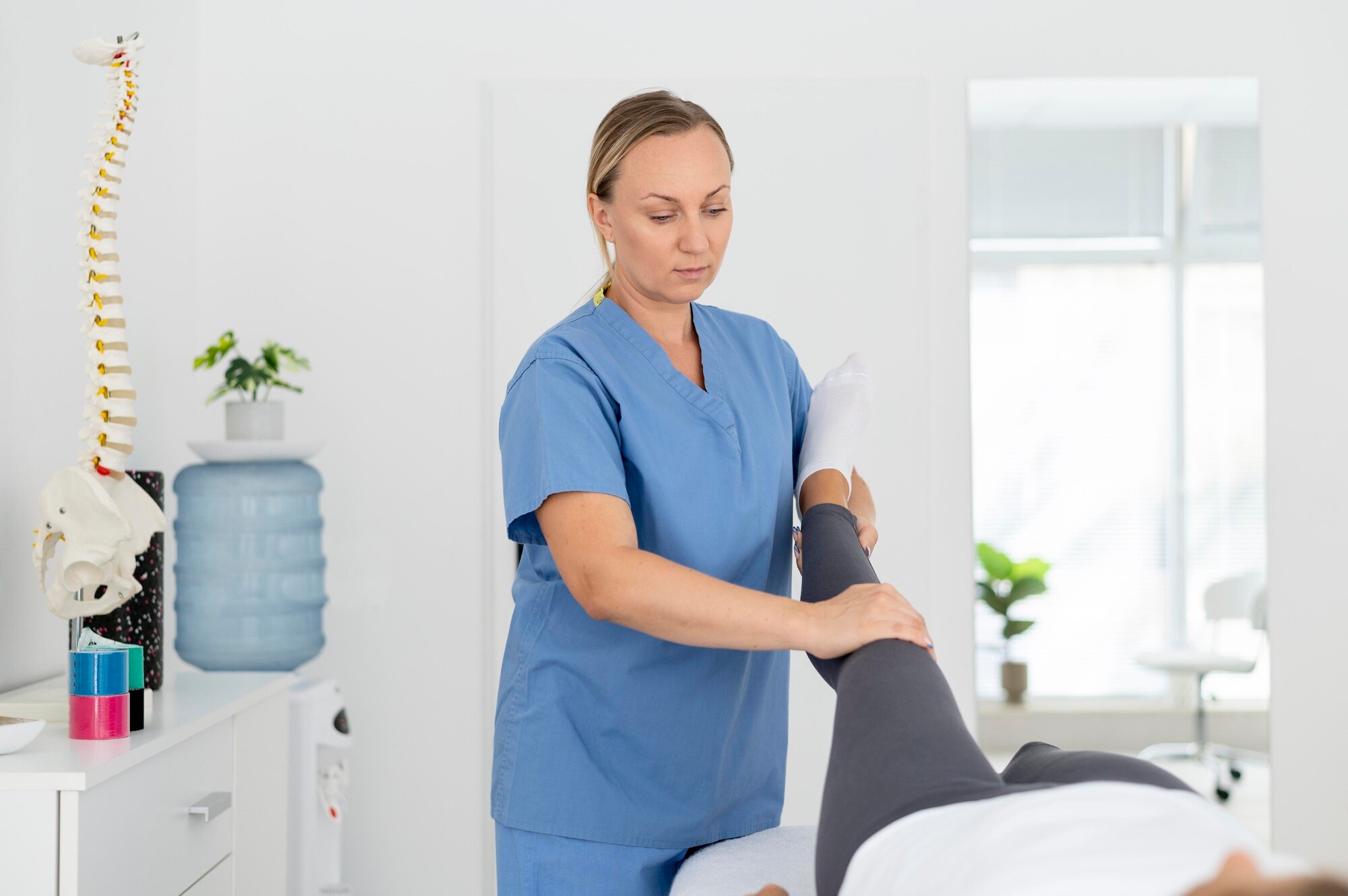 physiotherapist-helping-young-female-patient_23-2149115574