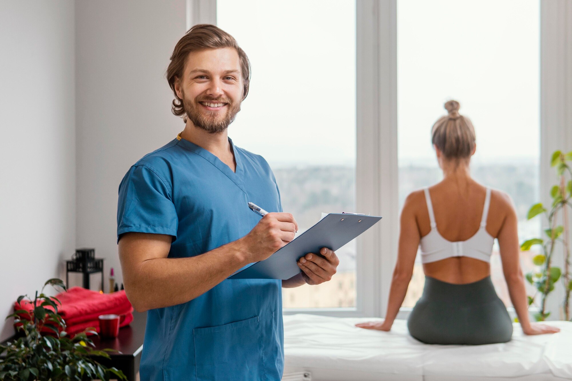 smiley-male-osteopathic-therapist-with-clipboard-female-patient-clinic_23-2148846591